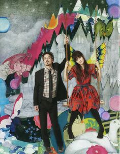 a man and woman standing next to each other in front of a collage of kites