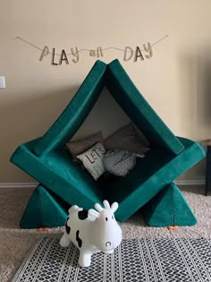 a cow statue sitting on top of a rug