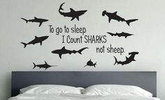 there is a bed with a wall sticker that says to go to sleep i don't sharks not sheep