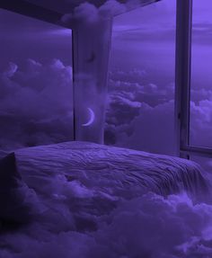 a bed sitting under a purple sky filled with clouds