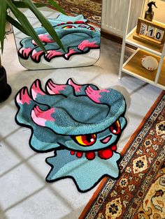 two bathroom rugs with an image of a dragon on them