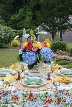 a table with flowers and plates on it