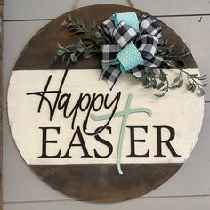 a sign that says happy easter hanging on the side of a building with a bow