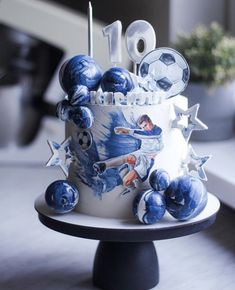 a birthday cake decorated with blue and white decorations