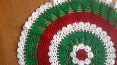 two crocheted placemats sitting on top of a wooden floor next to each other