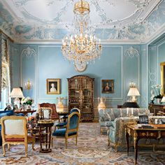 a living room filled with furniture and a chandelier