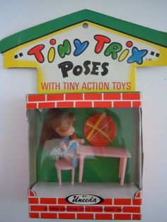 a toy house with a table and chair in the box on it's side