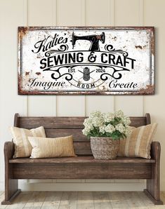 an old fashioned sewing and craft sign hangs above a wooden bench with pillows on it