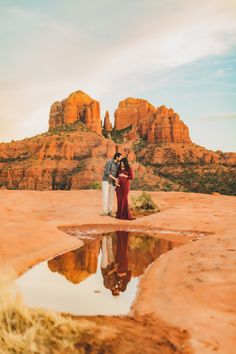 a couple standing next to each other in the desert