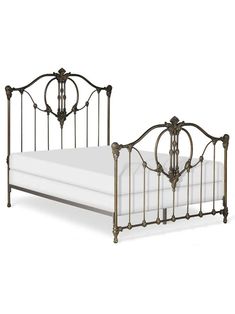 a metal bed frame with white sheets