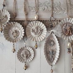 there are many ornaments hanging on the wall in this room, including seashells and bells