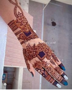 the hand is decorated with henna designs