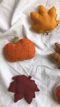 felt pumpkins and leaves on a white sheet