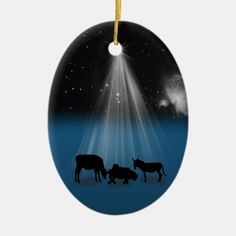 an ornament with three cows in the snow under a bright star filled sky