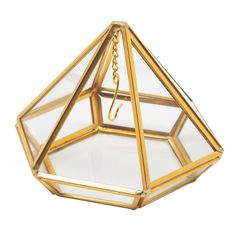 a glass and brass hanging light fixture on a white background with a chain attached to it