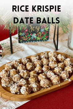 rice krispie date balls on a wooden platter with christmas decorations in the background