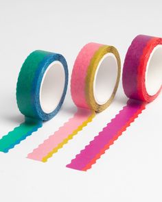 three rolls of colored tape sitting next to each other