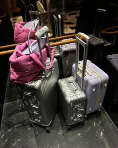 several pieces of luggage are stacked on top of each other in front of a mirror