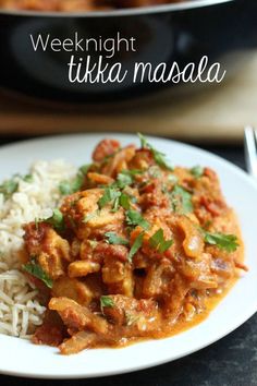 a white plate topped with chicken tikka masala