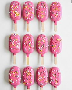 pink sprinkle covered pops with white and yellow sprinkles on them