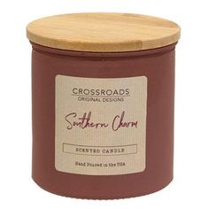 a candle with a wooden lid and label on the front that reads, southern charm