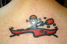 a person with a tattoo on their back that has an image of a monkey driving a car