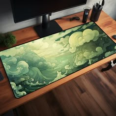 a computer desk with a painting on it