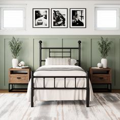 a bedroom with green walls and white bedding, two nightstands on either side of the bed