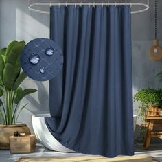 a blue shower curtain in a bathroom next to a potted plant