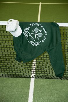 a tennis net with a green shirt and hat on it