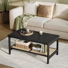 a living room with a white couch and black coffee table