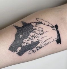 a couple of hands holding each other on top of a forearm tattoo designs for men and women