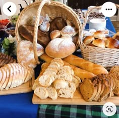 breads and pastries are displayed in baskets on a blue tablecloth with words above them