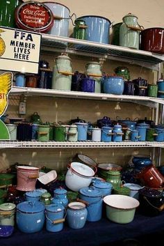 many pots and pans are stacked on shelves