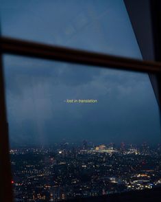 a view from the top of a building at night, looking out onto london and not in translation