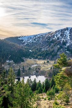 a scenic view of a mountain lake surrounded by trees