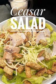 a salad with chicken, lettuce and parmesan cheese on the side