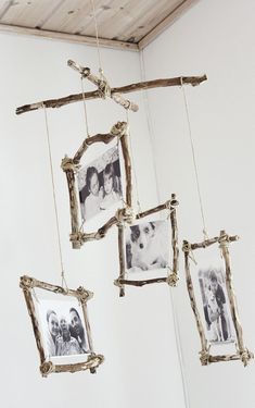 three frames hanging from the ceiling in front of a white wall with wood planks