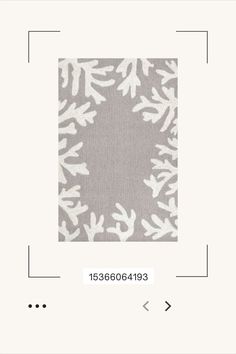 an image of a square with white flowers on grey and white fabric in the middle