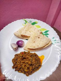 two tortillas on a white plate with garlic