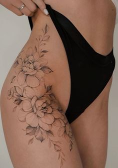 a woman's stomach with flowers on it and the bottom half of her body