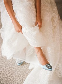 a woman in white dress and blue shoes