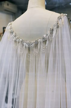 a white veil with beading on it