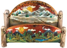 an artisticly painted wooden headboard with mountains in the background