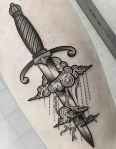 a black and white tattoo with a knife on it