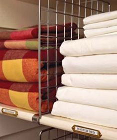 several folded towels are stacked in a metal rack