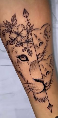 a tiger and lioness tattoo on the leg with flowers in it's head