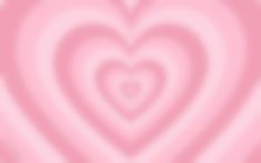 a blurry image of a heart in the middle of it's pink hues