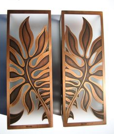 two decorative wooden panels with leaves on them