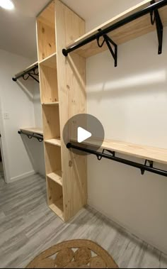 a walk in closet with wooden shelves and black brackets